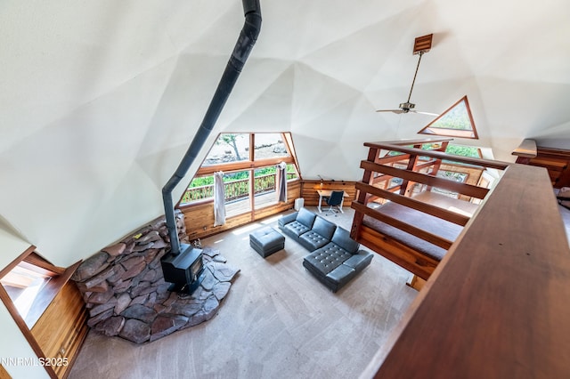 15118 N Timberline Dr, Reno, NV 89511 - living room with high vaulted ceiling, a wood stove, ceiling fan, and carpet
