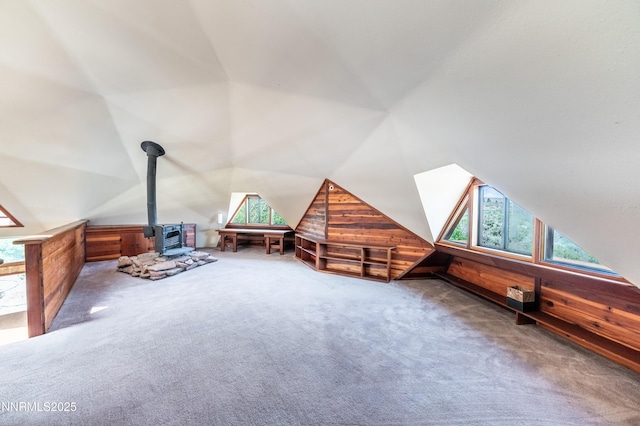 15118 N Timberline Dr, Reno, NV 89511 - additional living space featuring healthy amount of natural light, a wood stove, carpet floors, wood walls, and lofted ceiling