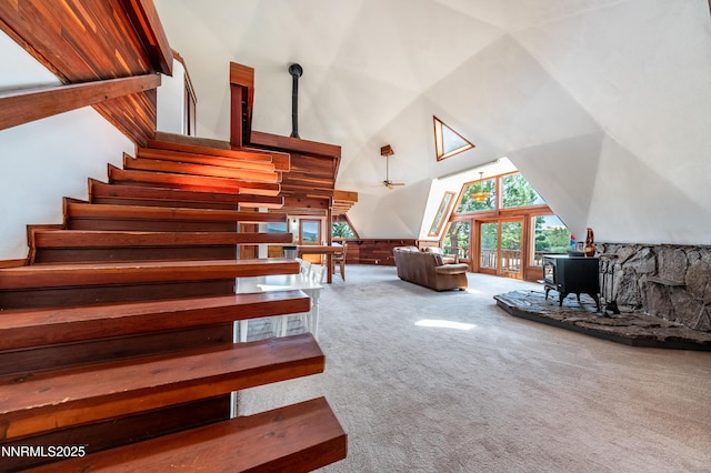 15118 N Timberline Dr, Reno, NV 89511 - staircase featuring a towering ceiling, a wood stove, and carpet floors