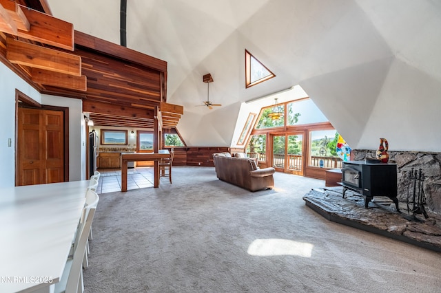 15118 N Timberline Dr, Reno, NV 89511 - carpeted living room featuring a wood stove, high vaulted ceiling, and a ceiling fan