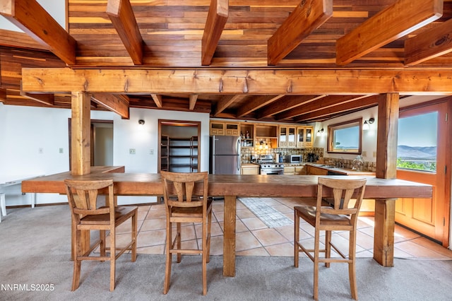 15118 N Timberline Dr, Reno, NV 89511 - dining room with wood ceiling with exposed beams, light carpet, and light tile patterned floors
