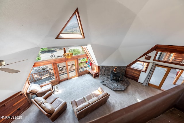 15118 N Timberline Dr, Reno, NV 89511 - carpeted living area with healthy amount of natural light, a wood stove, high vaulted ceiling, and a ceiling fan
