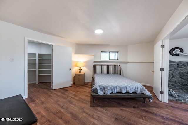 15118 N Timberline Dr, Reno, NV 89511 - bedroom with wood finished floors, a spacious closet, and baseboards