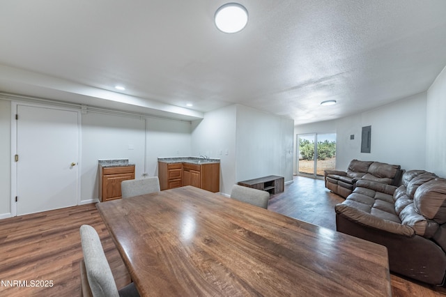 15118 N Timberline Dr, Reno, NV 89511 - dining room featuring dark wood-style floors, wet bar, electric panel, recessed lighting, and a textured ceiling