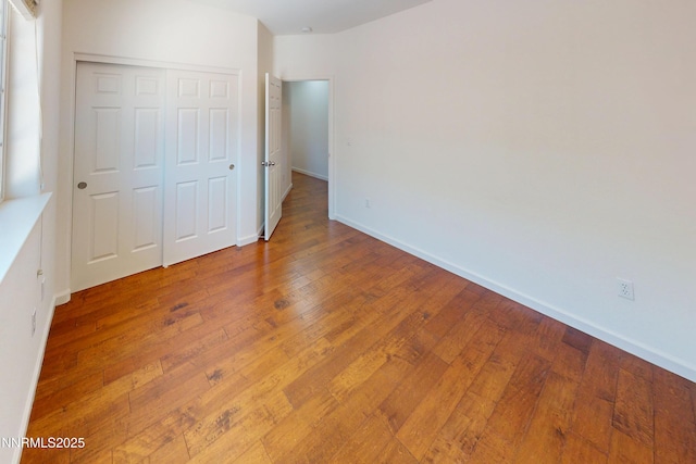 1509 Lasso Ln, Gardnerville, NV 89410 - unfurnished bedroom with a closet, wood-type flooring, and baseboards