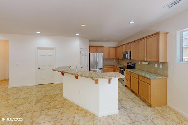 1509 Lasso Ln, Gardnerville, NV 89410 - kitchen featuring stainless steel appliances, decorative backsplash, recessed lighting, a breakfast bar area, and light stone countertops