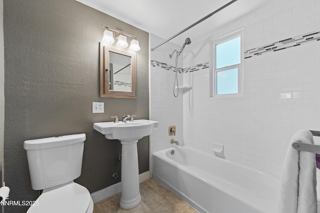 621 9th St, Sparks, NV 89431 - full bathroom with toilet, washtub / shower combination, a textured wall, and baseboards