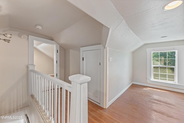 621 9th St, Sparks, NV 89431 - additional living space with lofted ceiling, light wood-style floors, baseboards, and a textured ceiling