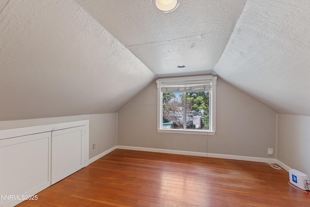 621 9th St, Sparks, NV 89431 - additional living space with a textured ceiling, light wood finished floors, baseboards, and vaulted ceiling