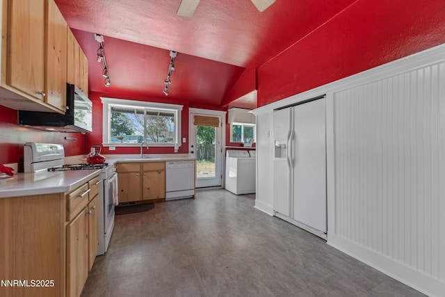 621 9th St, Sparks, NV 89431 - kitchen with white appliances, light countertops, a sink, washing machine and dryer, and vaulted ceiling
