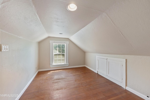 621 9th St, Sparks, NV 89431 - bonus room with a textured ceiling, wood-type flooring, vaulted ceiling, and baseboards
