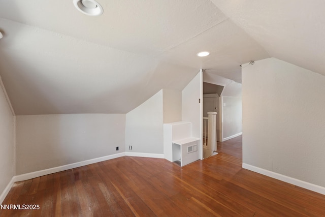 621 9th St, Sparks, NV 89431 - additional living space with vaulted ceiling, baseboards, and wood-type flooring