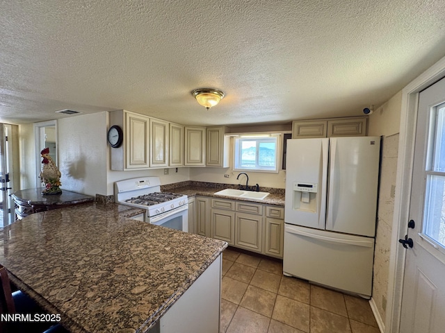 13995 Grass Valley Rd, Winnemucca, NV 89445 - kitchen with white appliances, a sink, a peninsula, cream cabinetry, and a textured ceiling