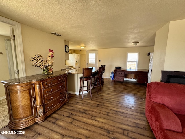 13995 Grass Valley Rd, Winnemucca, NV 89445 - dining room with a textured ceiling, dark wood-type flooring, and baseboards