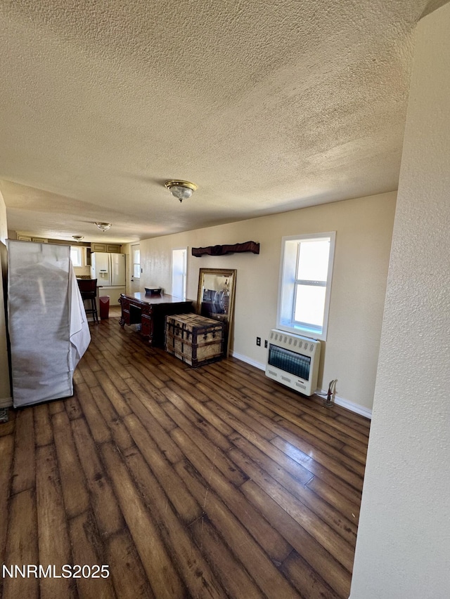 13995 Grass Valley Rd, Winnemucca, NV 89445 - living area with heating unit, a textured ceiling, dark wood finished floors, and baseboards