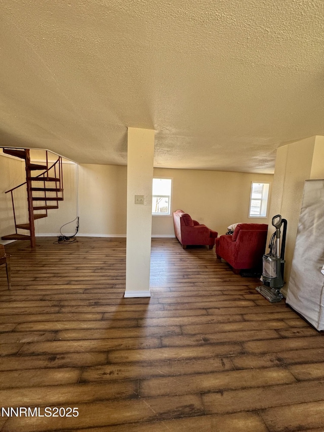 13995 Grass Valley Rd, Winnemucca, NV 89445 - below grade area featuring a textured ceiling, hardwood / wood-style flooring, and baseboards