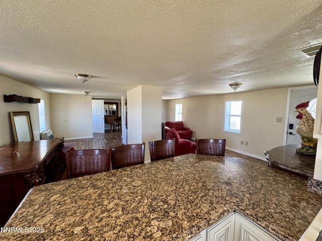 13995 Grass Valley Rd, Winnemucca, NV 89445 - dining room with baseboards and a textured ceiling