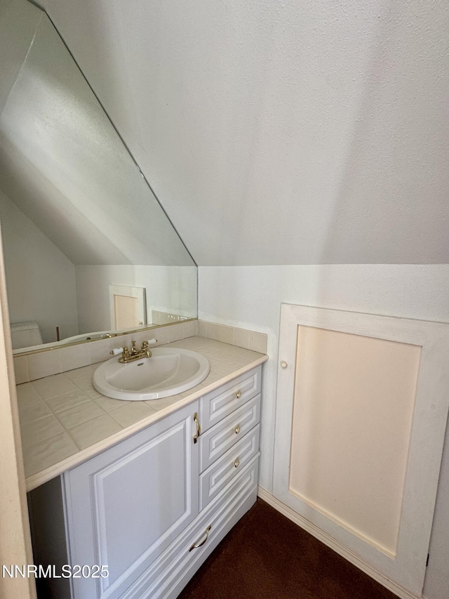 13995 Grass Valley Rd, Winnemucca, NV 89445 - bathroom featuring vaulted ceiling, vanity, and toilet