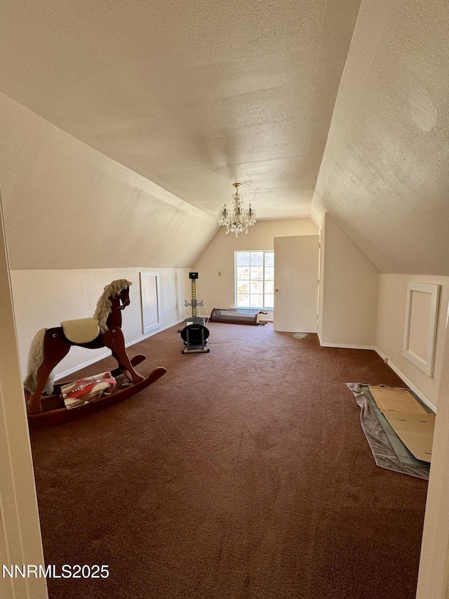 13995 Grass Valley Rd, Winnemucca, NV 89445 - bonus room with a textured ceiling, carpet floors, lofted ceiling, baseboards, and a chandelier
