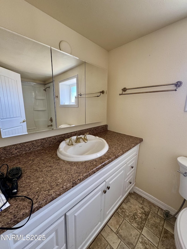 13995 Grass Valley Rd, Winnemucca, NV 89445 - full bathroom with toilet, vanity, baseboards, and a shower