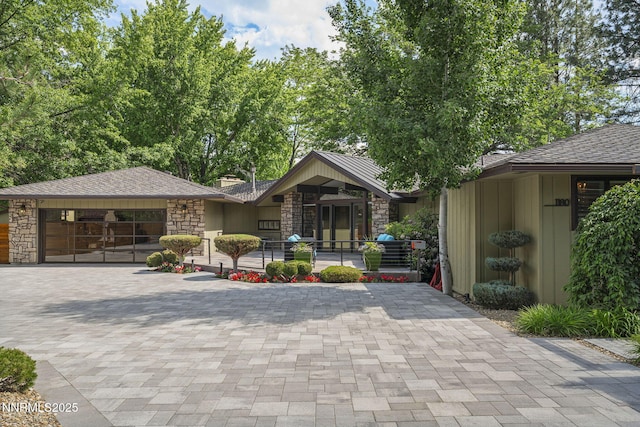 1180 Manzanita Ln, Reno, NV 89509 - view of front of house with stone siding, driveway, and an attached garage