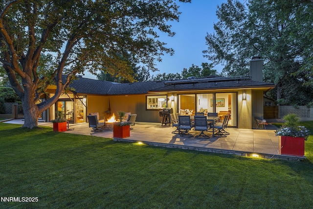 1180 Manzanita Ln, Reno, NV 89509 - rear view of house with an outdoor fire pit, a patio area, a chimney, and a lawn