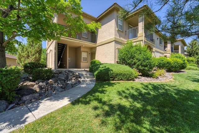 6850 Sharlands Ave Unit F2030, Reno, NV 89523 - view of exterior entry featuring stucco siding and a lawn