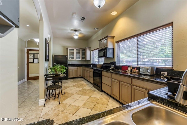 6850 Sharlands Ave Unit F2030, Reno, NV 89523 - kitchen with black appliances, light tile patterned floors, dark countertops, glass insert cabinets, and recessed lighting
