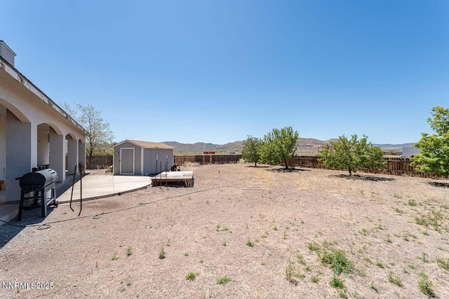 4945 Broken Spur Rd, Reno, NV 89510 - fenced backyard with a patio and a mountain view