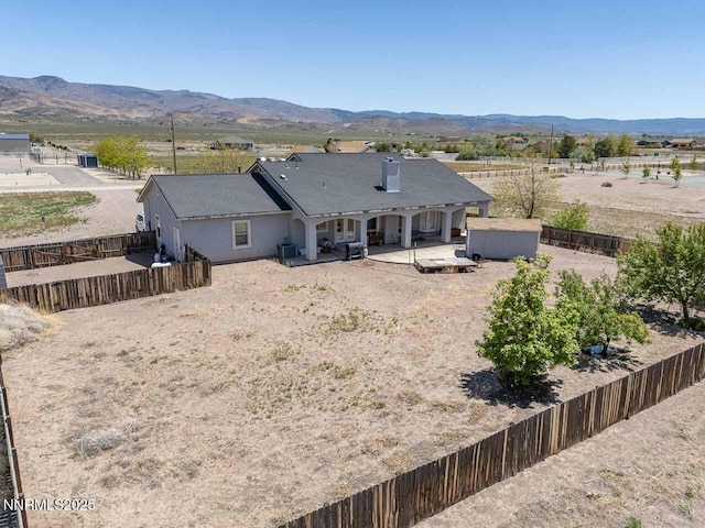 4945 Broken Spur Rd, Reno, NV 89510 - back of house with a patio, a mountain view, and a fenced backyard