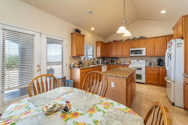 4945 Broken Spur Rd, Reno, NV 89510 - kitchen featuring white appliances, a sink, lofted ceiling, tasteful backsplash, and a kitchen island