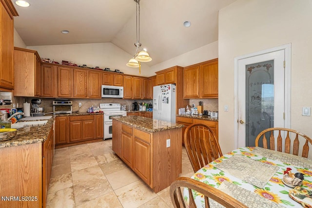 4945 Broken Spur Rd, Reno, NV 89510 - kitchen with white appliances, a sink, dark stone counters, backsplash, and high vaulted ceiling