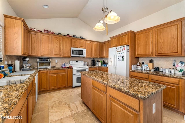 4945 Broken Spur Rd, Reno, NV 89510 - kitchen featuring white appliances, a kitchen island, brown cabinetry, and high vaulted ceiling