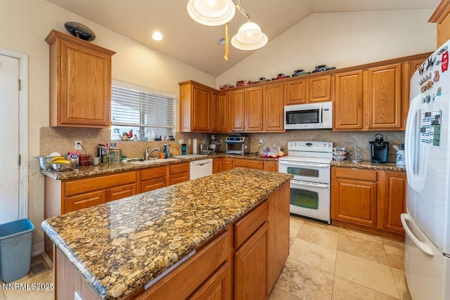 4945 Broken Spur Rd, Reno, NV 89510 - kitchen featuring white appliances, a sink, vaulted ceiling, decorative backsplash, and a center island