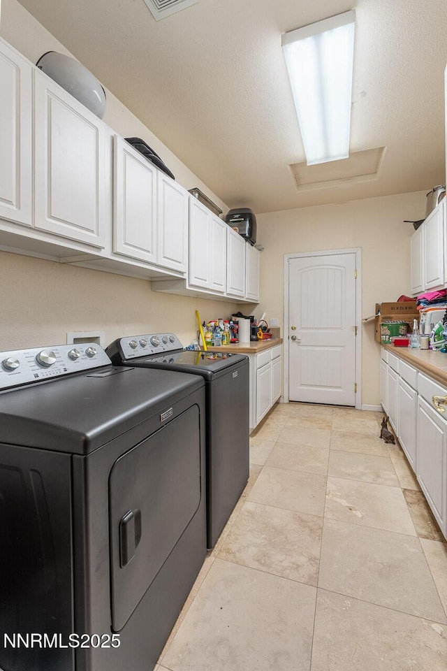 4945 Broken Spur Rd, Reno, NV 89510 - laundry room with cabinet space, independent washer and dryer, attic access, and light tile patterned floors