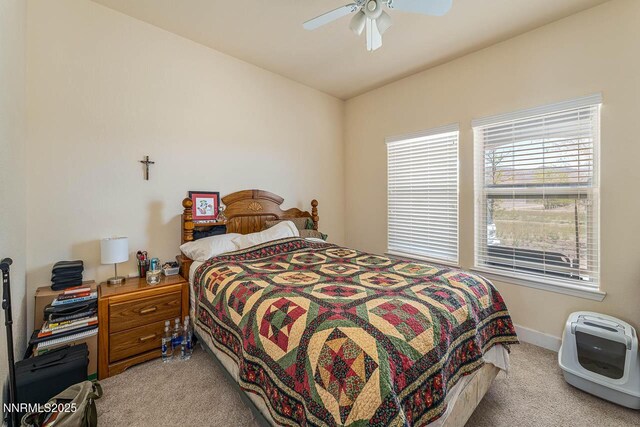 4945 Broken Spur Rd, Reno, NV 89510 - bedroom featuring light colored carpet, multiple windows, baseboards, and a ceiling fan