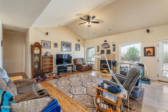 4945 Broken Spur Rd, Reno, NV 89510 - living room with ceiling fan, a tile fireplace, vaulted ceiling, and baseboards
