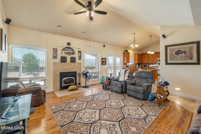 4945 Broken Spur Rd, Reno, NV 89510 - living area featuring ceiling fan, lofted ceiling, plenty of natural light, baseboards, and light wood-style flooring