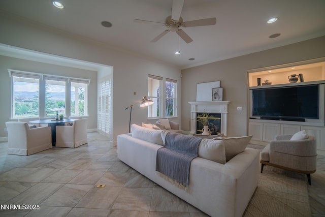 8270 Antler Pointe Ct, Reno, NV 89523 - living room featuring plenty of natural light, a ceiling fan, ornamental molding, a glass covered fireplace, and recessed lighting