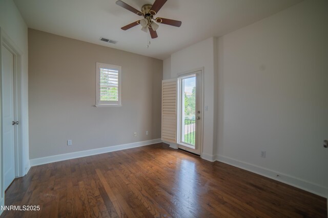8270 Antler Pointe Ct, Reno, NV 89523 - empty room with plenty of natural light, a ceiling fan, and dark wood-style flooring