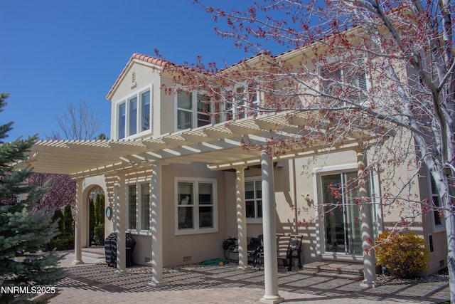 8270 Antler Pointe Ct, Reno, NV 89523 - back of property featuring a pergola, stucco siding, a patio area, and a tiled roof