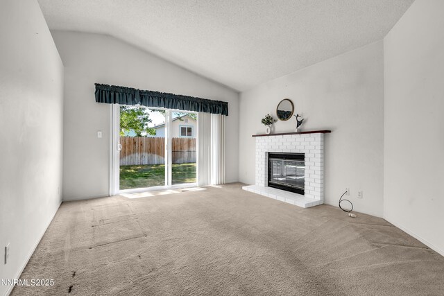 3353 Alpland Ln, Sparks, NV 89434 - unfurnished living room featuring lofted ceiling, carpet floors, a brick fireplace, and a textured ceiling