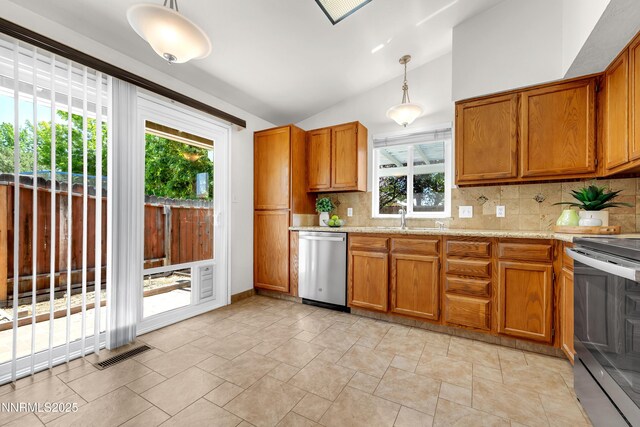 3353 Alpland Ln, Sparks, NV 89434 - kitchen featuring appliances with stainless steel finishes, plenty of natural light, brown cabinetry, and lofted ceiling