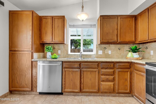 3353 Alpland Ln, Sparks, NV 89434 - kitchen featuring appliances with stainless steel finishes, lofted ceiling, brown cabinets, tasteful backsplash, and decorative light fixtures