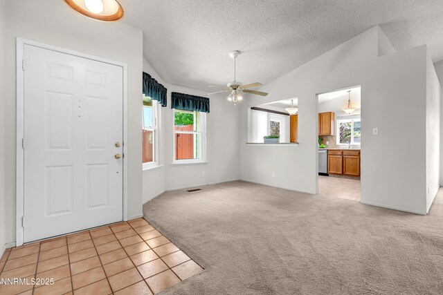 3353 Alpland Ln, Sparks, NV 89434 - entrance foyer featuring light carpet, a ceiling fan, a textured ceiling, vaulted ceiling, and light tile patterned floors