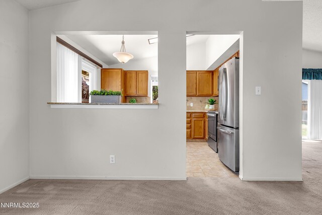 3353 Alpland Ln, Sparks, NV 89434 - kitchen with light carpet, freestanding refrigerator, brown cabinets, tasteful backsplash, and light countertops