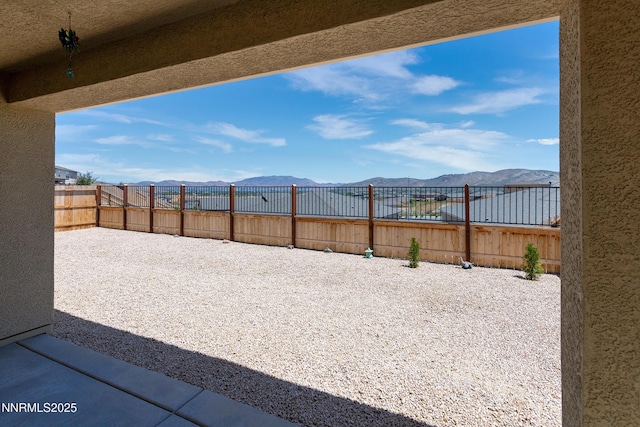 353 Radiant Dr, Carson City, NV 89705 - fenced backyard featuring a mountain view and a patio