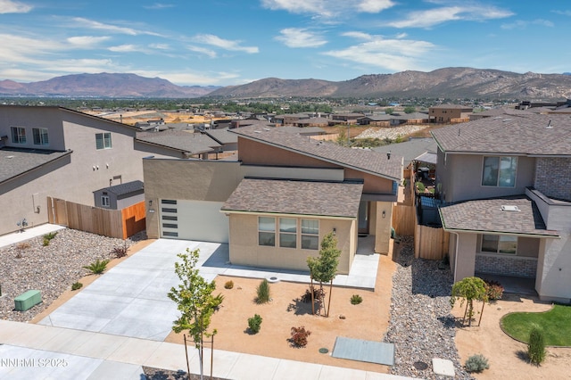 353 Radiant Dr, Carson City, NV 89705 - view of front of property with a residential view, concrete driveway, a mountain view, and stucco siding