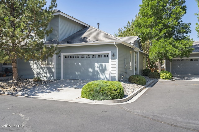 6694 Aston Cir, Sparks, NV 89436 - view of side of property featuring a garage and concrete driveway
