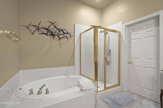 6694 Aston Cir, Sparks, NV 89436 - bathroom featuring a shower stall, a bath, and a textured wall
